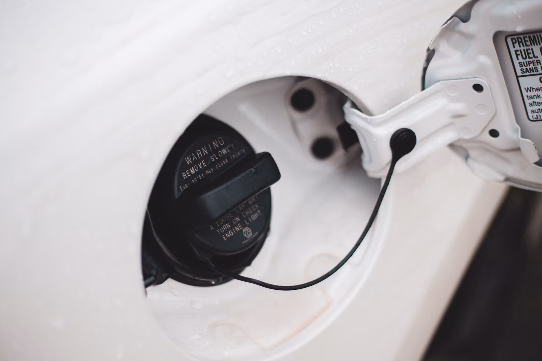 There is an image of a gas cap on a car.