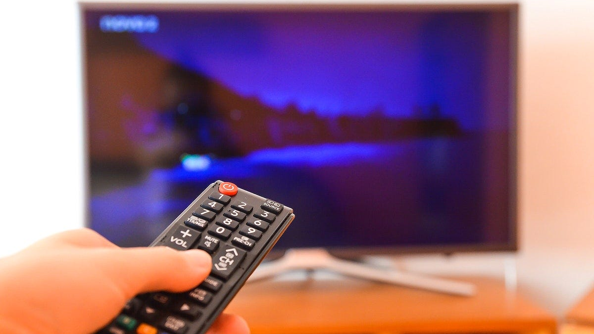 Remote pointed at a TV showing a streaming service menu